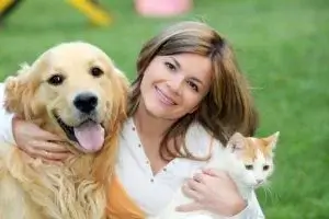 Woman with dog and cat indicating PawPurity offers natural uni-pet care products